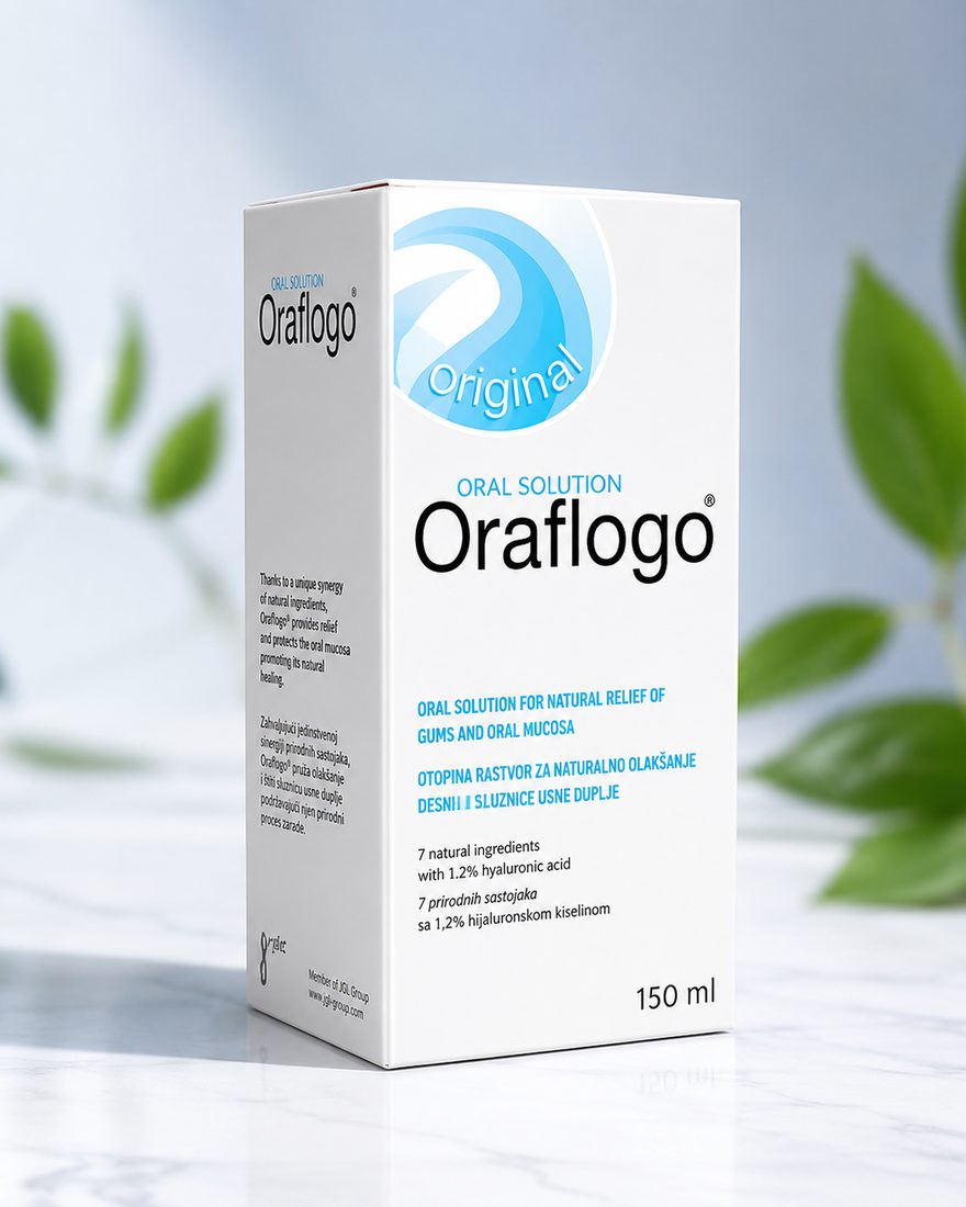 The Oraflogo Oral Solution carton on a marble surface beside fresh green leaves
